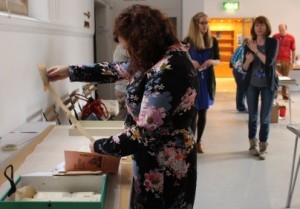 Exploring Woman looking at item from box-file